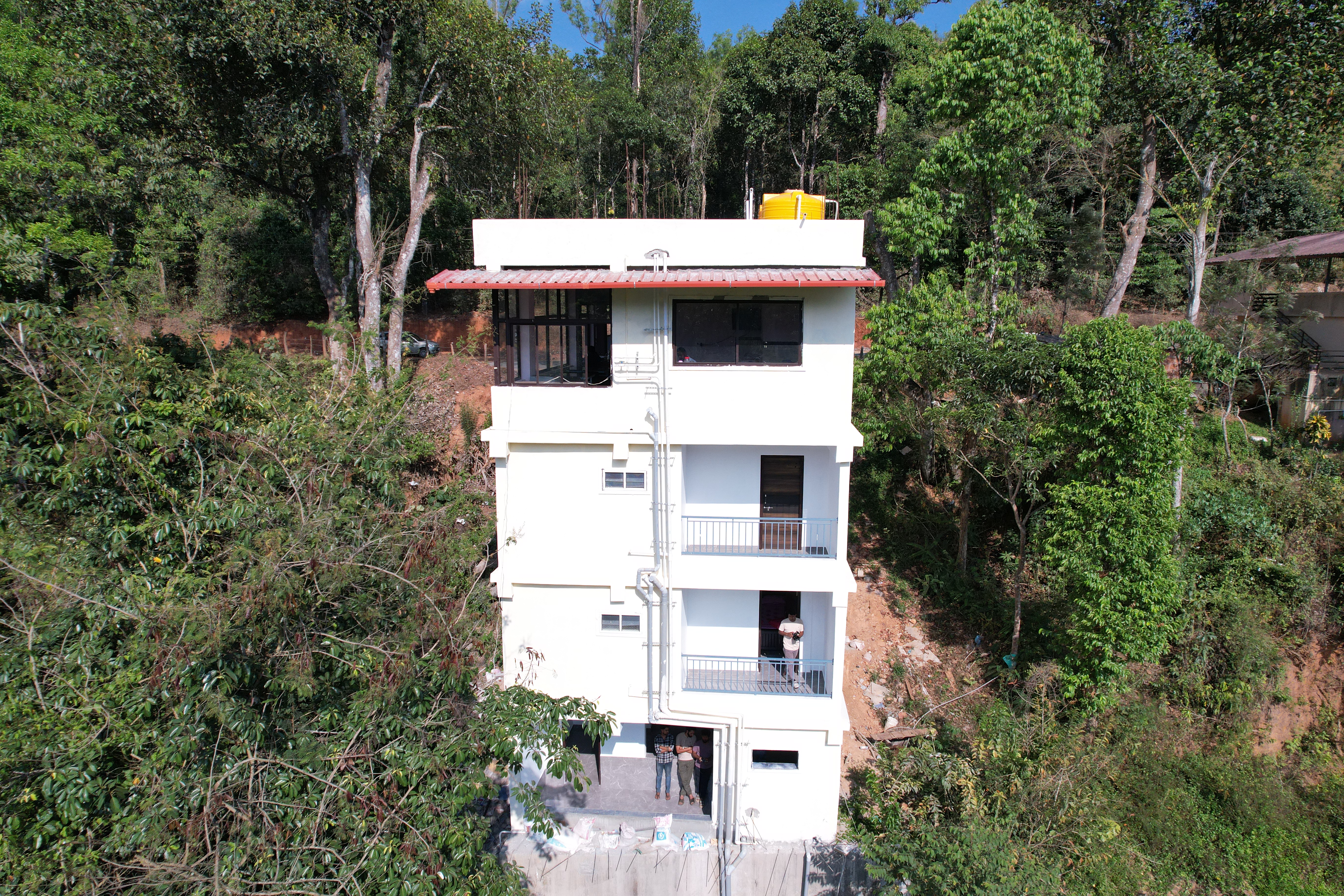 Exterior view of Thotadmane Homestay surrounded by trees